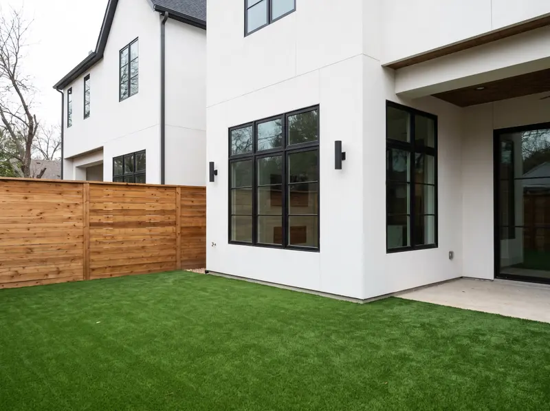 Synthetic turf backyard with a horizontal cedar fence