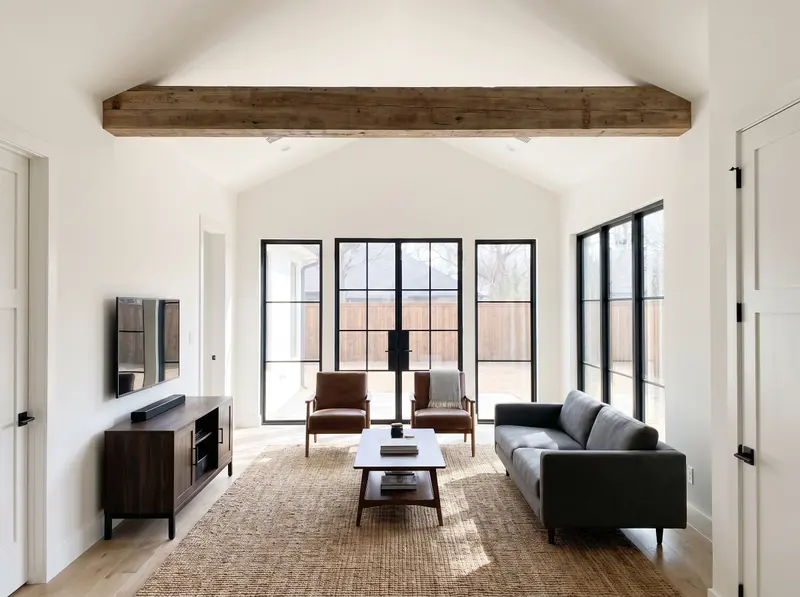 Living room with a raised vaulted ceiling and an exposed wood beam